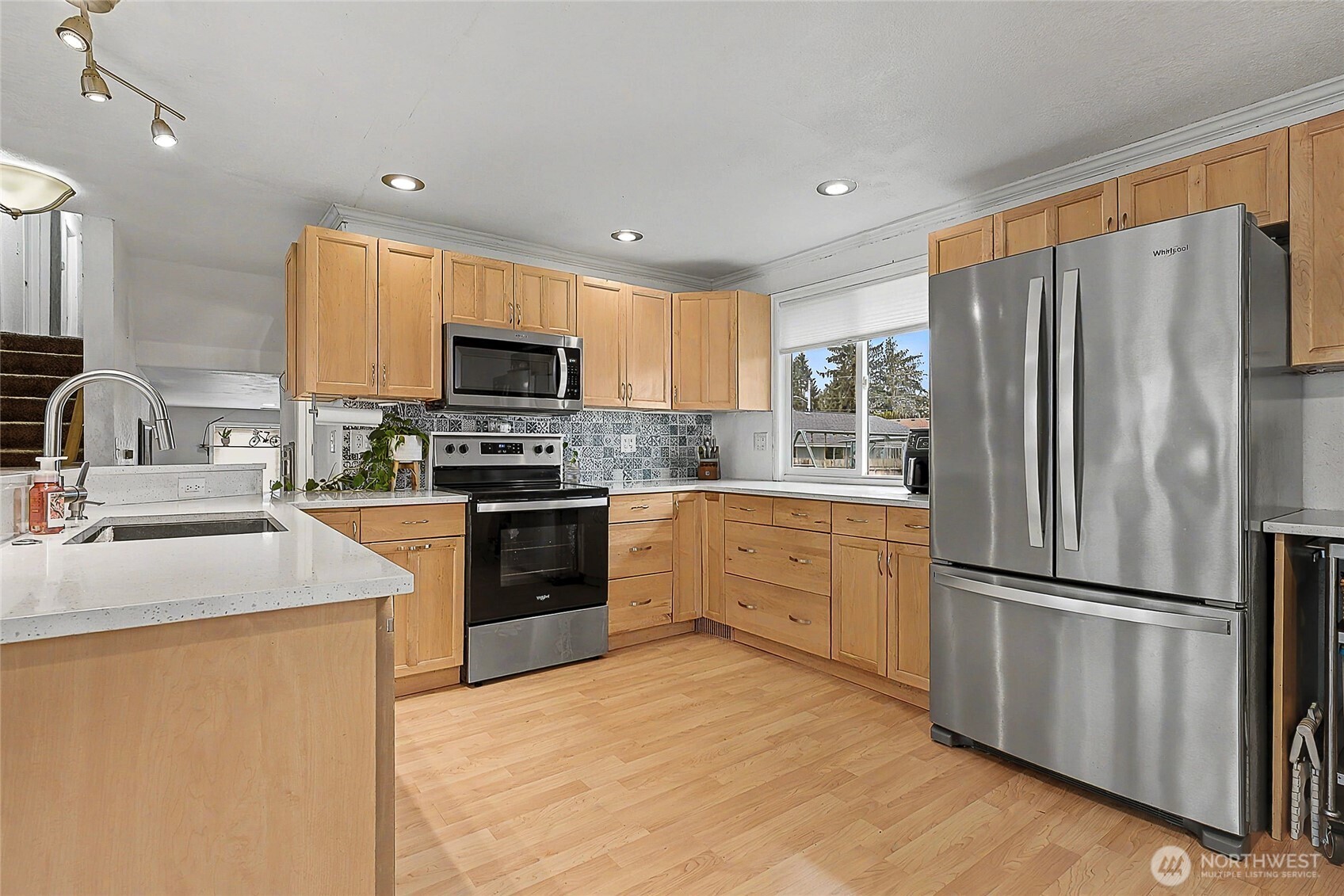 6003 Armour Loop Southeast Olympia, WA 98513 - Photo 8 of 25 a kitchen with granite countertop stainless steel appliances and refrigerator
