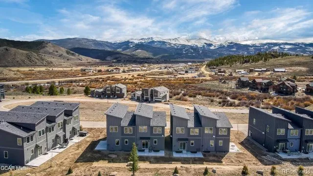 a view of a house with a wooden fence