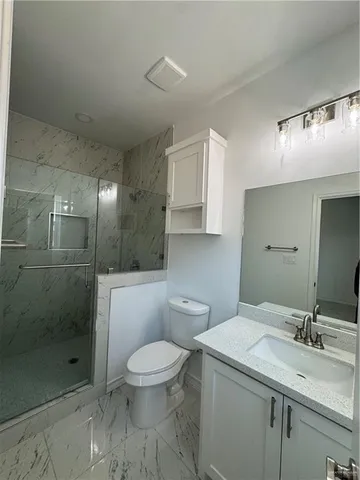 a bathroom with a toilet sink and shower