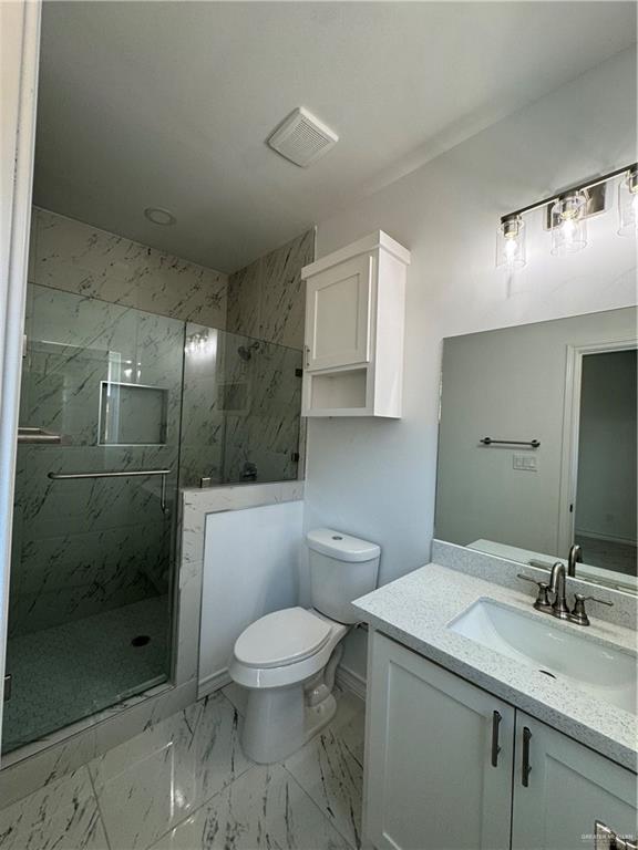 2101 Selena Street, Unit 1 Mission, TX 78572 - Photo 17 of 18 a bathroom with a toilet sink and shower