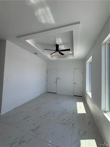 a large white kitchen with a refrigerator a stove top oven a sink and cabinets