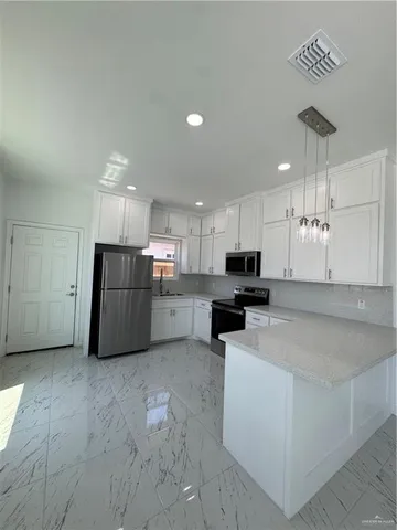 a kitchen with stainless steel appliances granite countertop a refrigerator sink and cabinets