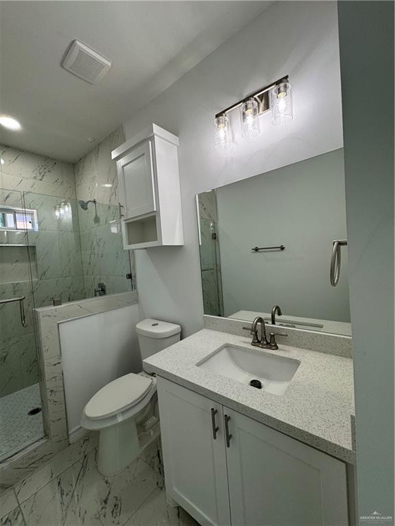 2101 Selena Street, Unit 1 Mission, TX 78572 - Photo 7 of 18 a bathroom with a toilet sink and mirror