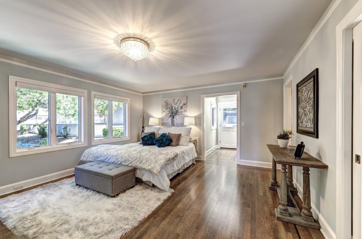 17915 Foster Road Los Gatos, CA 95030 - Photo 13 of 30 a spacious bedroom with a large bed and a chandelier