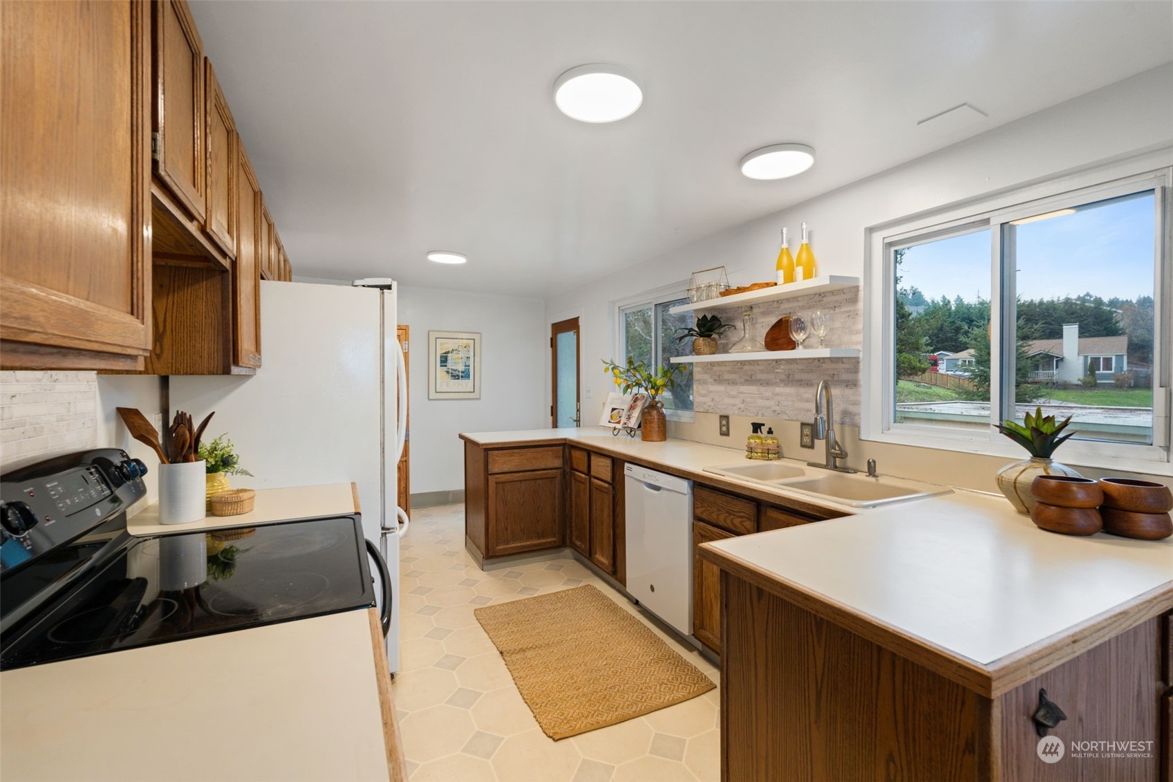 913 Powell Street Steilacoom, WA 98388 - Photo 11 of 40 a kitchen with a sink a stove and cabinets