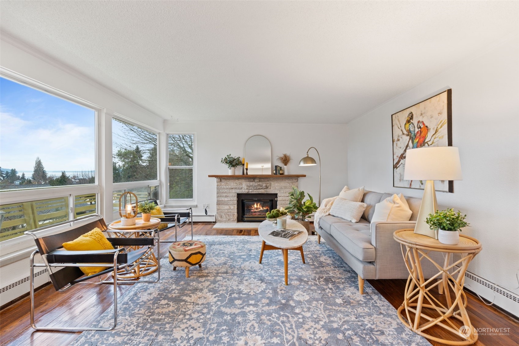 913 Powell Street Steilacoom, WA 98388 - Photo 13 of 40 a living room with furniture a fireplace and a floor to ceiling window