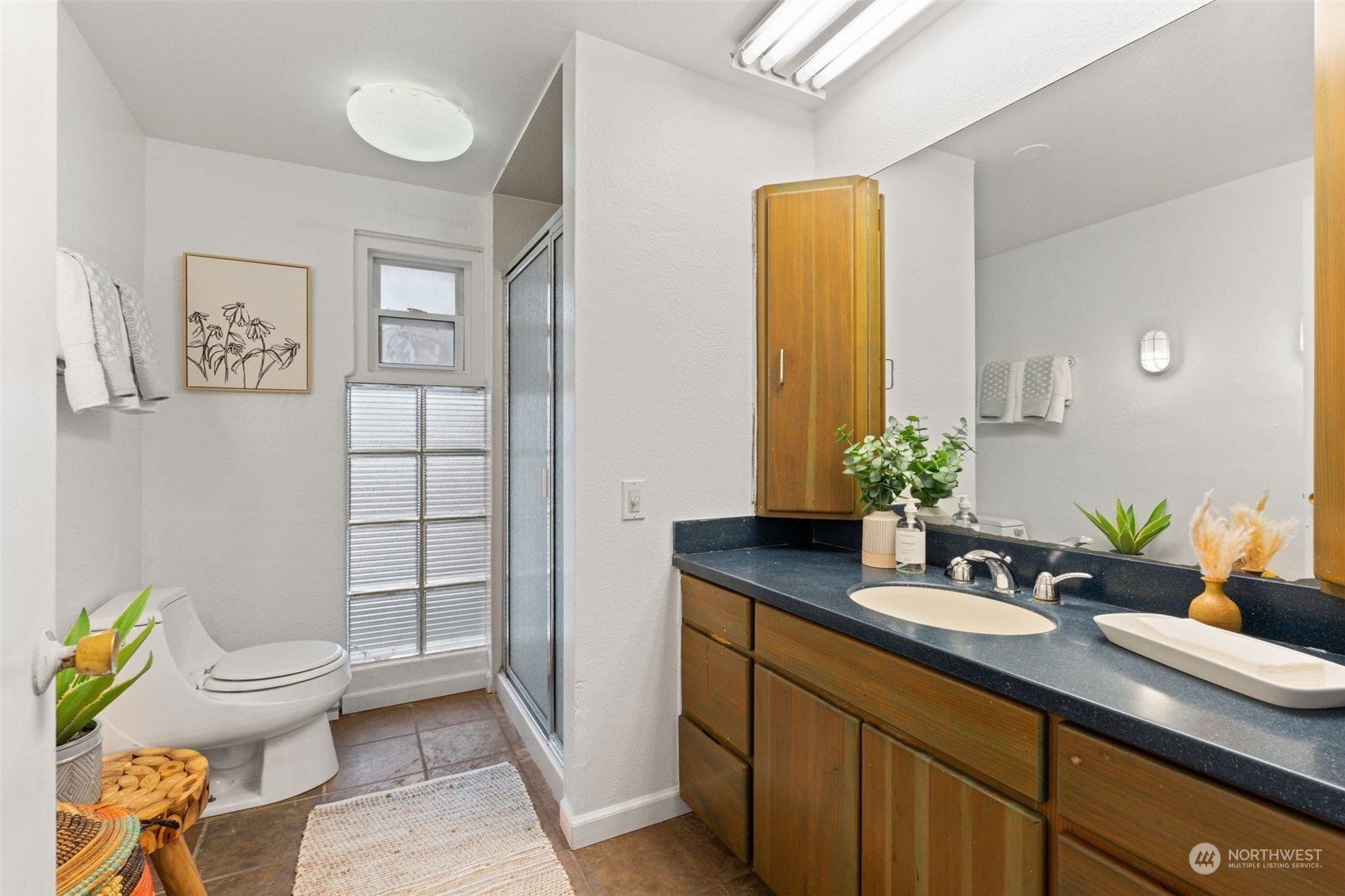 913 Powell Street Steilacoom, WA 98388 - Photo 19 of 40 a bathroom with a granite countertop toilet sink and mirror