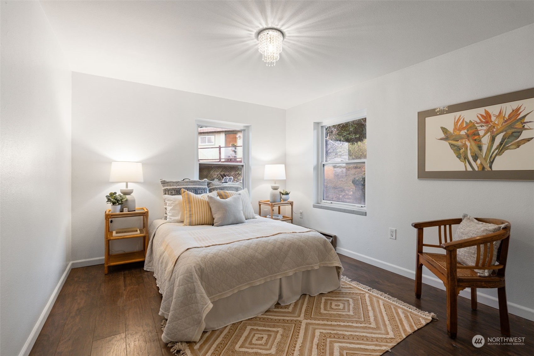 913 Powell Street Steilacoom, WA 98388 - Photo 24 of 40 a bedroom with a bed and a chandelier