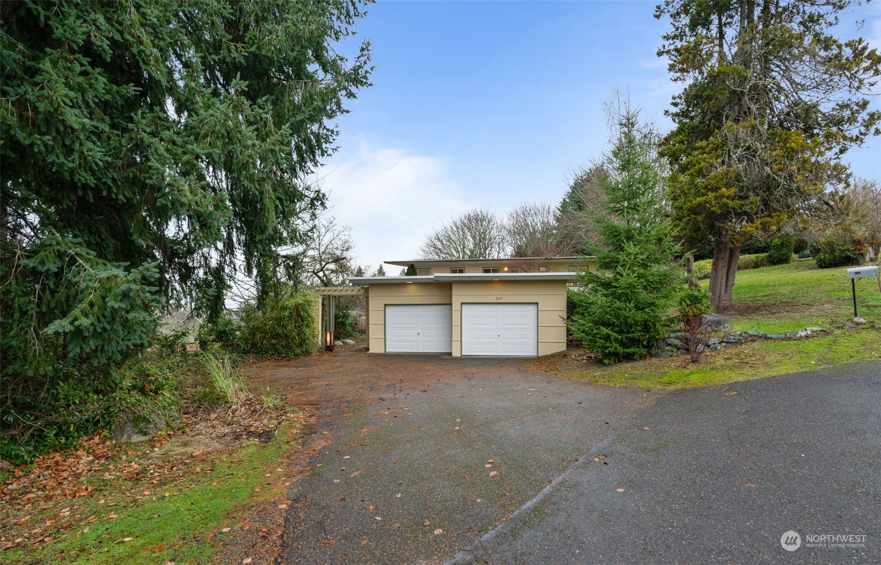 913 Powell Street Steilacoom, WA 98388 - Photo 39 of 40 a view of a house with a yard and garage