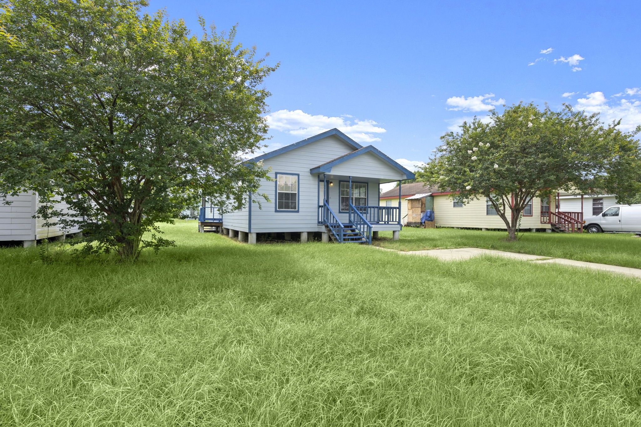 1935 1st Street Hempstead, TX 77445 - Photo 3 of 29 a view of house in front of a big yard with large trees