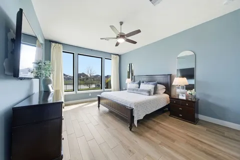 a bedroom with a large bed and a large window