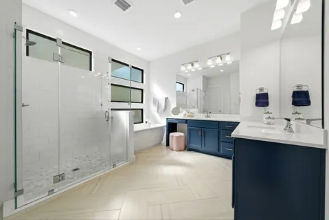 a bathroom with a sink shower and a mirror