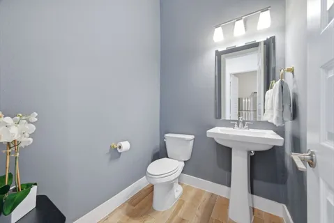 a bathroom with a toilet sink and mirror