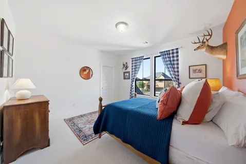 a bed room with a bed and a chair