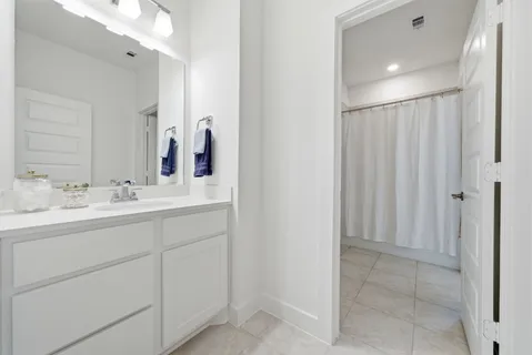 a bathroom with a double vanity sink and a mirror