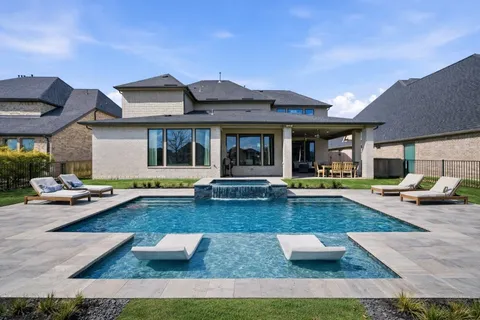 a view of a house with swimming pool and sitting area
