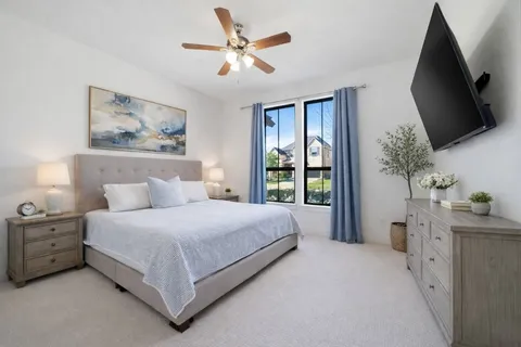 a spacious bedroom with a large bed and a flat screen tv