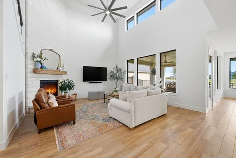 a living room with fireplace furniture and a flat screen tv