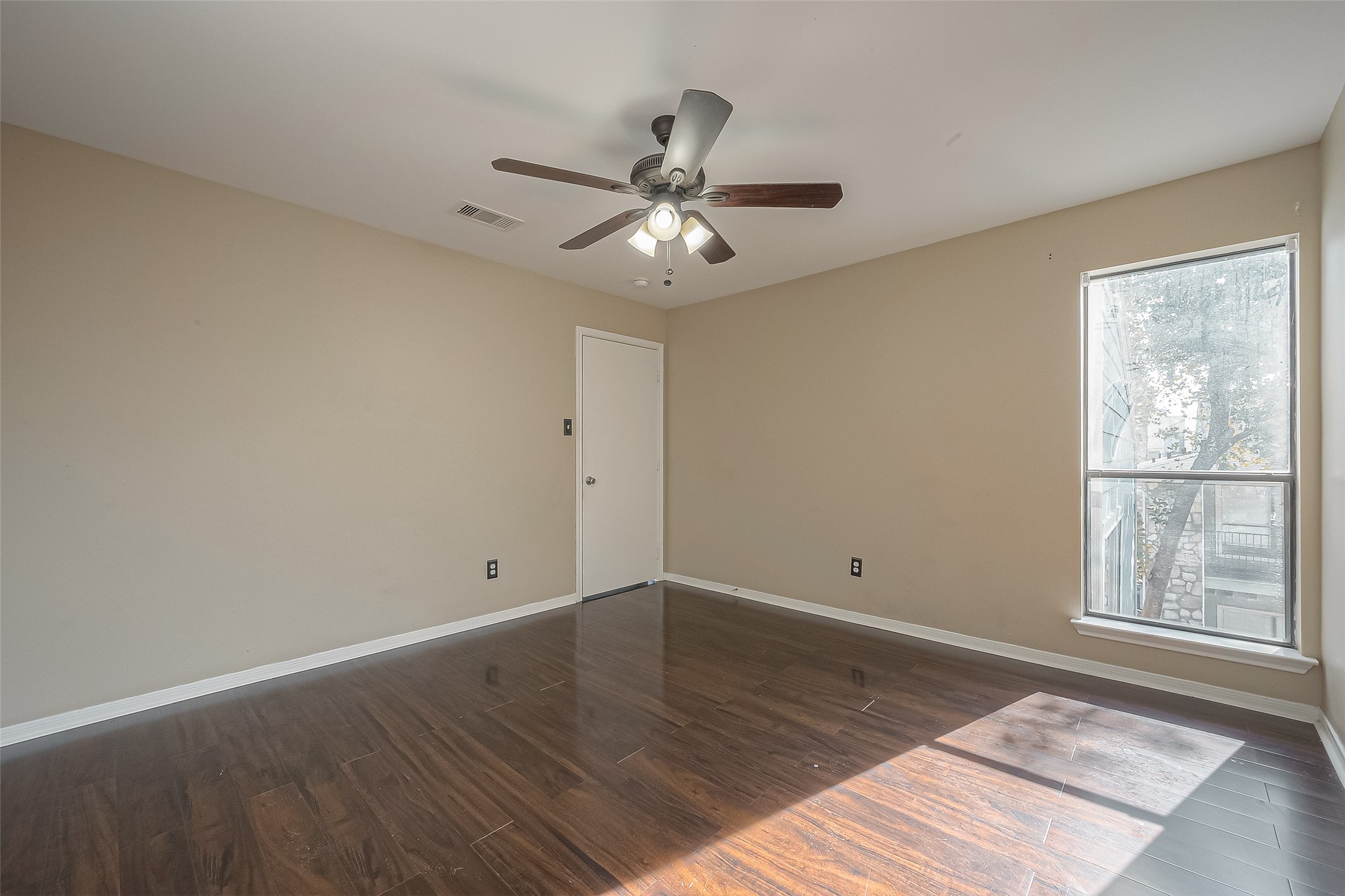 3758 Tanglewilde Street, Unit 2 Houston, TX 77063 - Photo 15 of 23 wooden floor in an empty room with a window