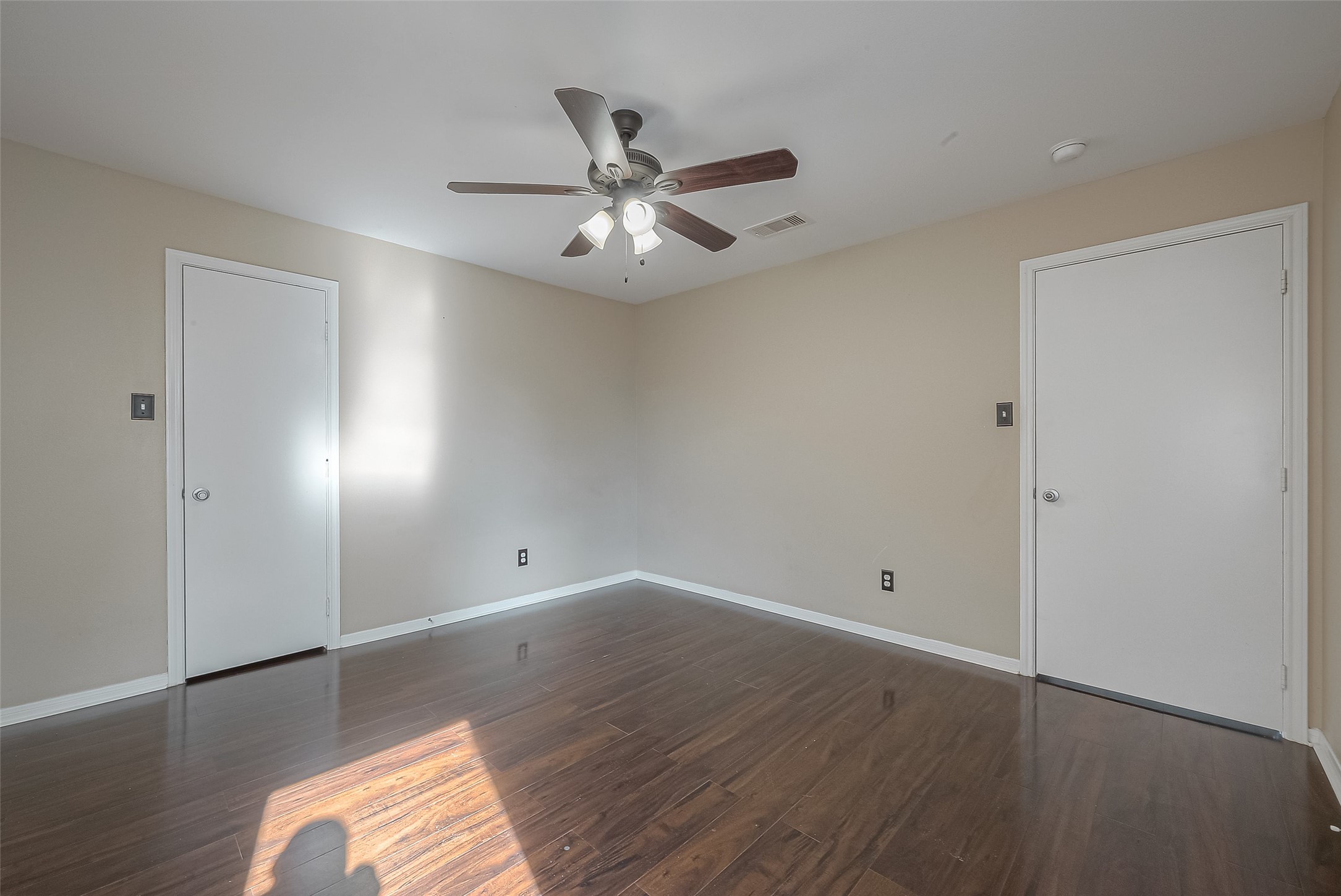 3758 Tanglewilde Street, Unit 2 Houston, TX 77063 - Photo 16 of 23 an empty room with wooden floor fan and windows