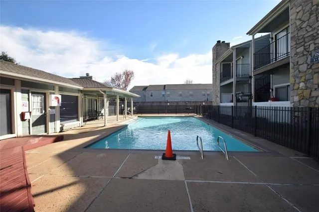 a view of a house with a swimming pool and a yard