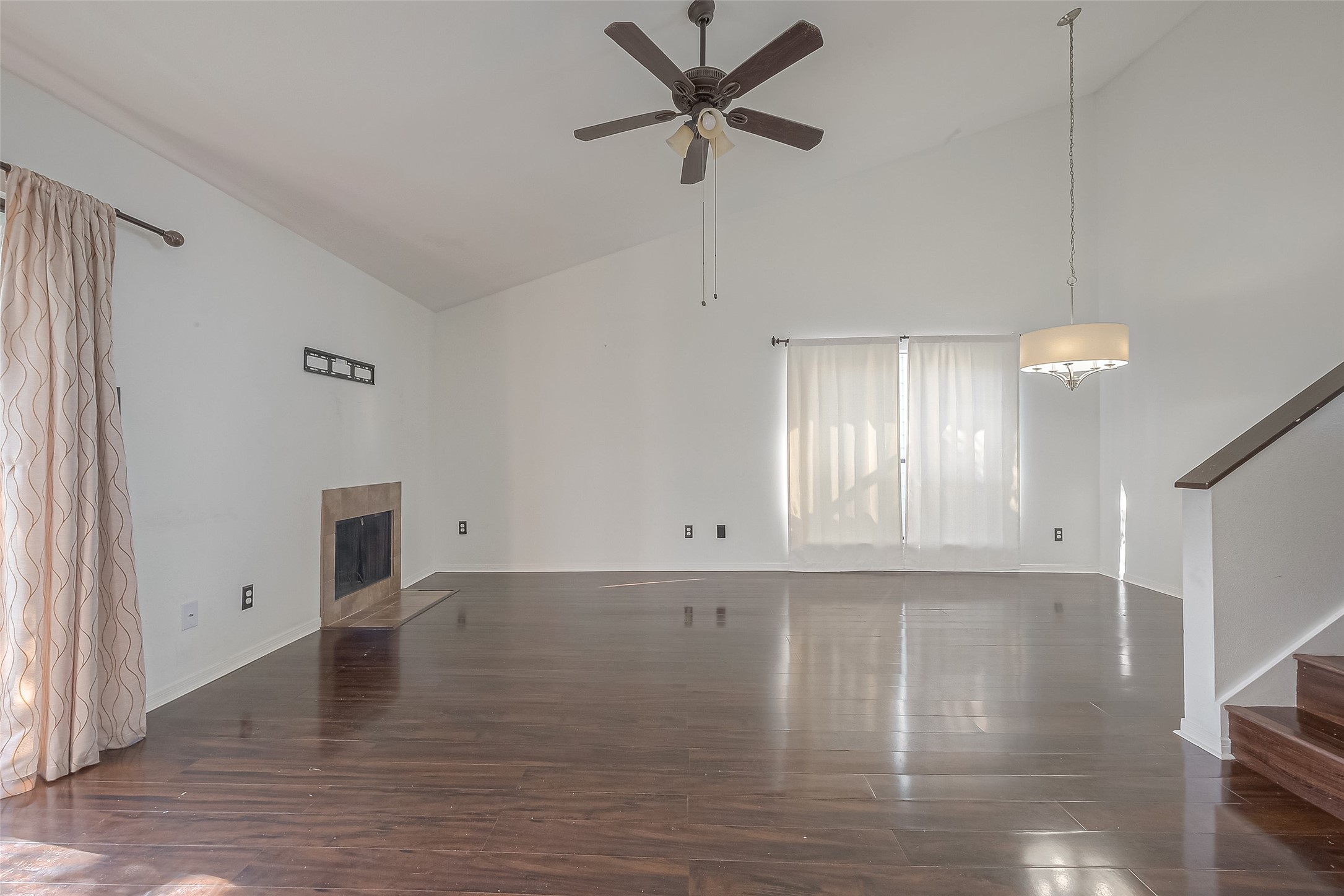 3758 Tanglewilde Street, Unit 2 Houston, TX 77063 - Photo 4 of 23 a view of an empty room with window and wooden floor