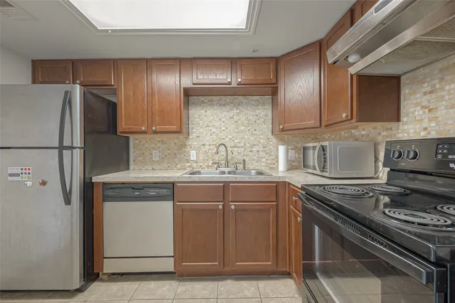 a kitchen with a sink a stove and refrigerator