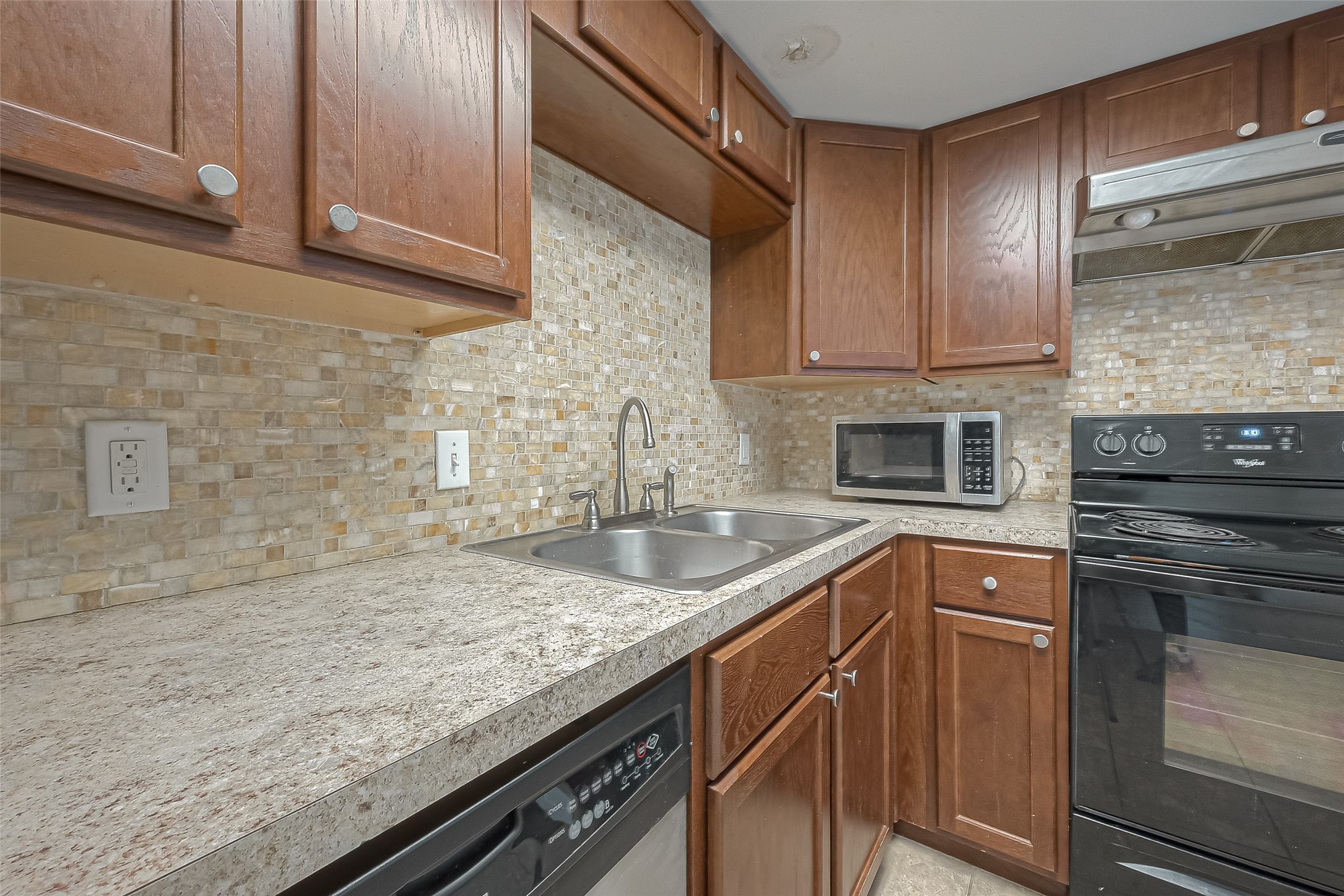 3758 Tanglewilde Street, Unit 2 Houston, TX 77063 - Photo 10 of 23 a kitchen with granite countertop stainless steel appliances and sink