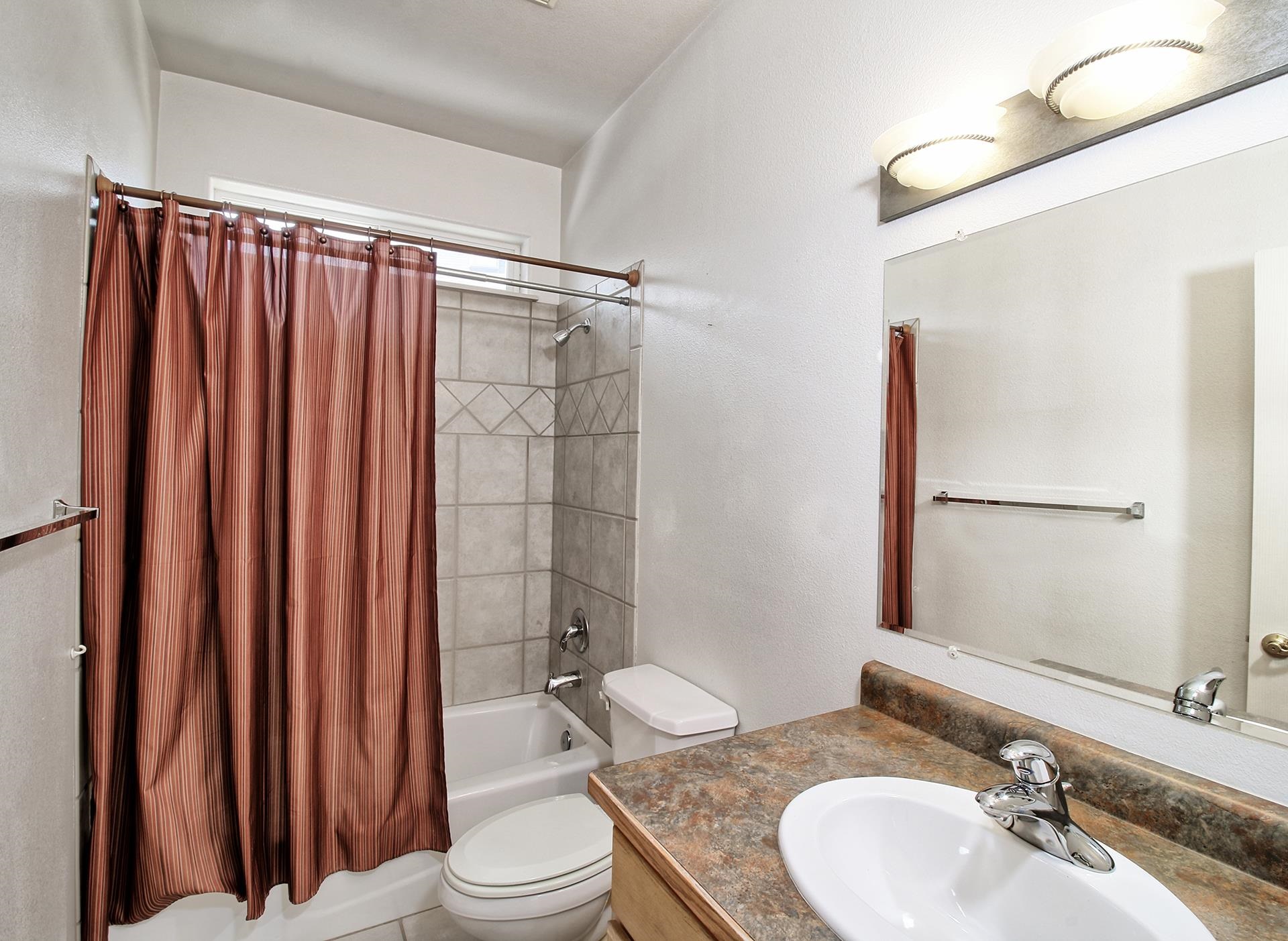 2211 Victorian Court Grand Junction, CO 81507 - Photo 17 of 42 a bathroom with a granite countertop sink toilet and shower