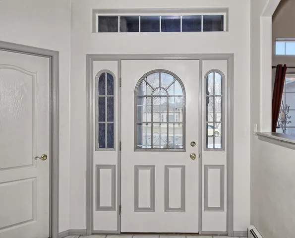 a view of front door with wooden floor