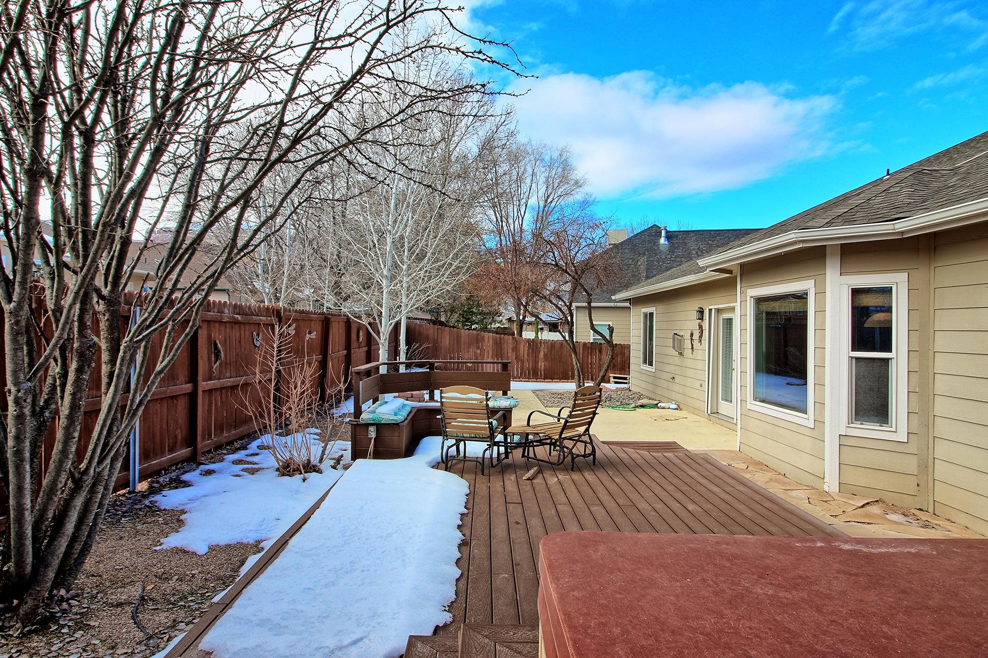 2211 Victorian Court Grand Junction, CO 81507 - Photo 2 of 42 a view of a patio with table and chairs and floor to ceiling window
