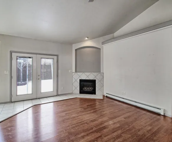 wooden floor fireplace and natural light in room