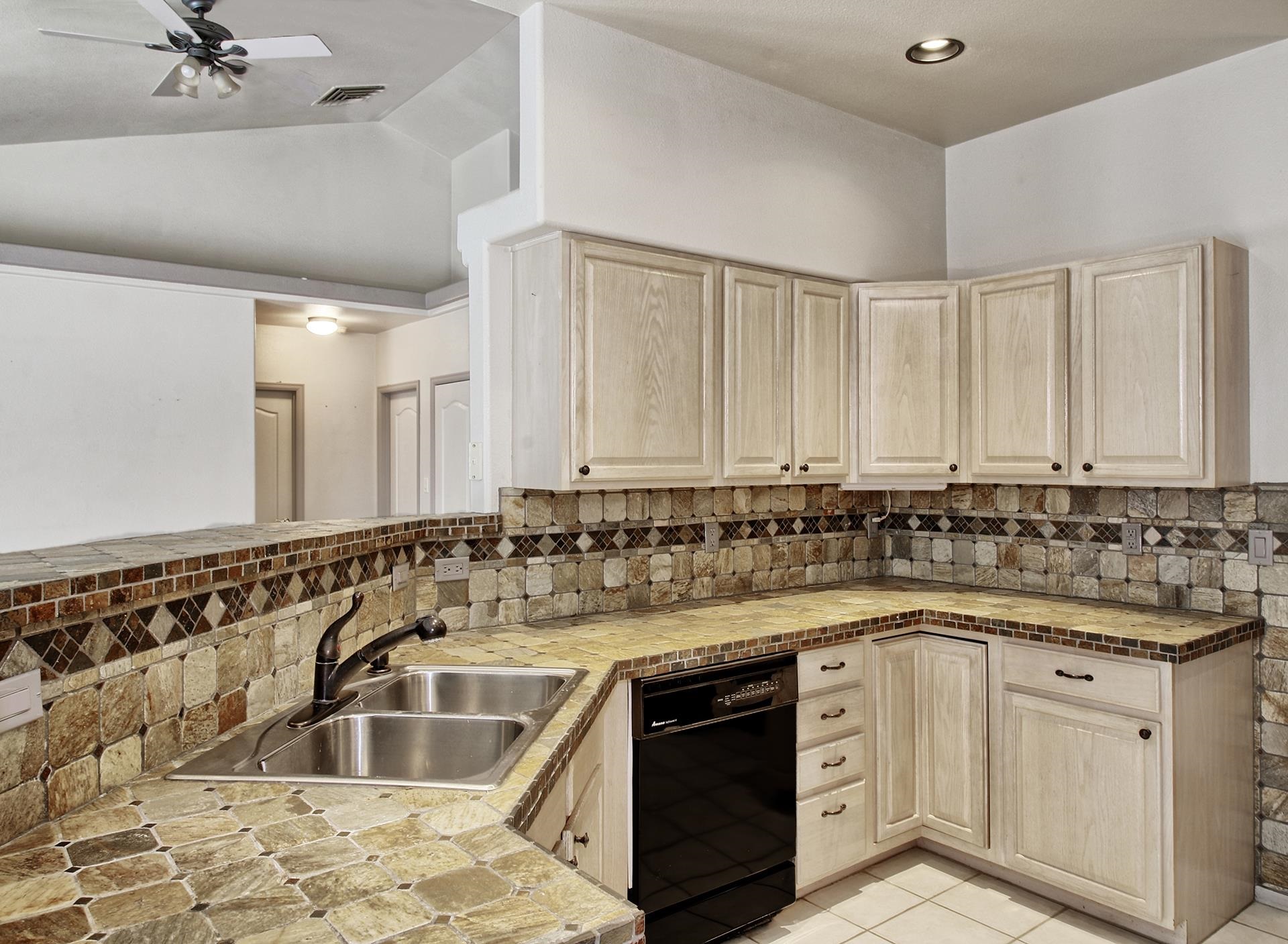 2211 Victorian Court Grand Junction, CO 81507 - Photo 28 of 42 a kitchen with a sink stove and cabinets