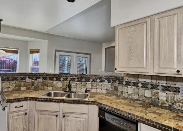 a view of a kitchen with granite countertop a sink