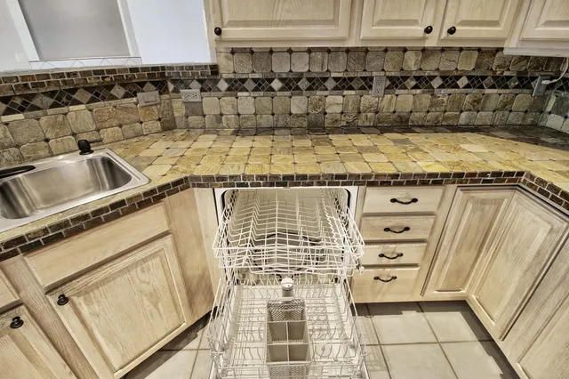 a stove top oven sitting inside of a kitchen