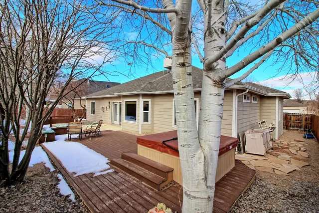 a view of a house with backyard and sitting area