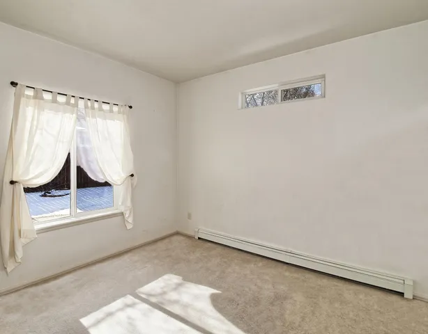 a view of a room with wooden floor and windows