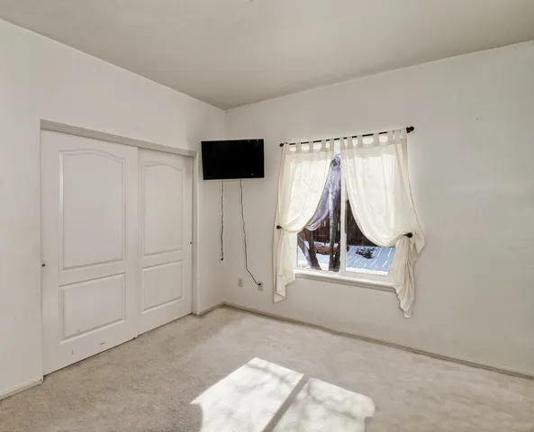an entryway with a flat screen tv and a window