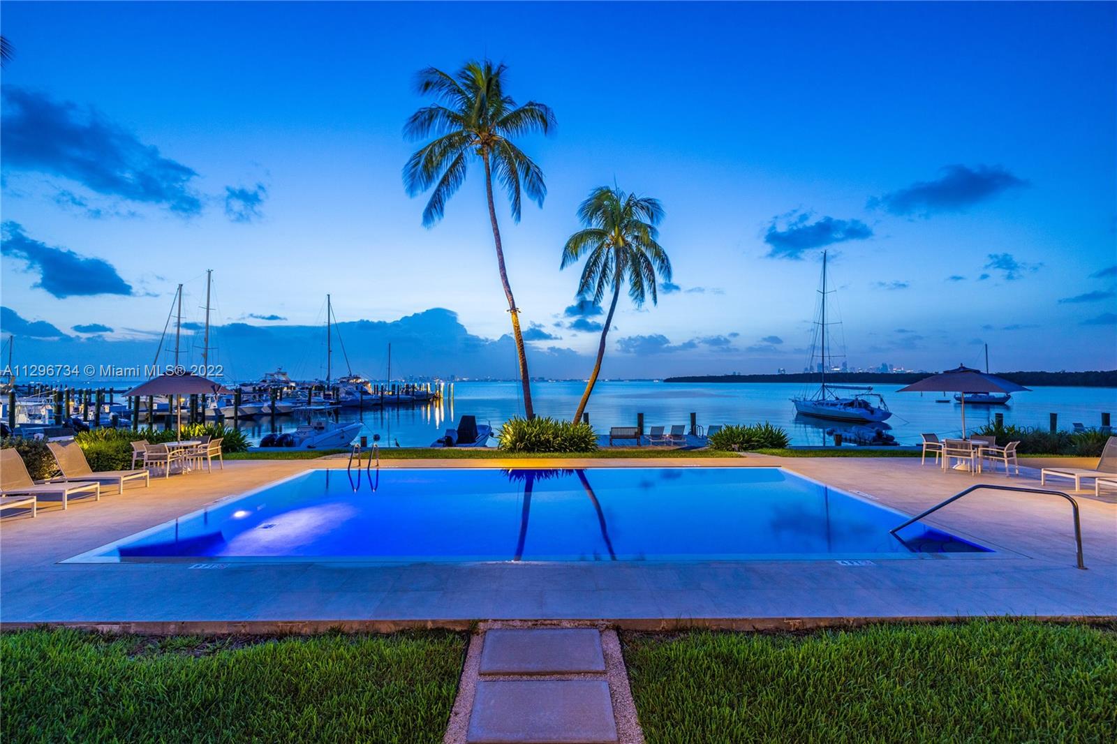 166 Harbor Drive, Unit 1A Key Biscayne, FL 33149 - Photo 15 of 86 a swimming pool with outdoor seating and yard