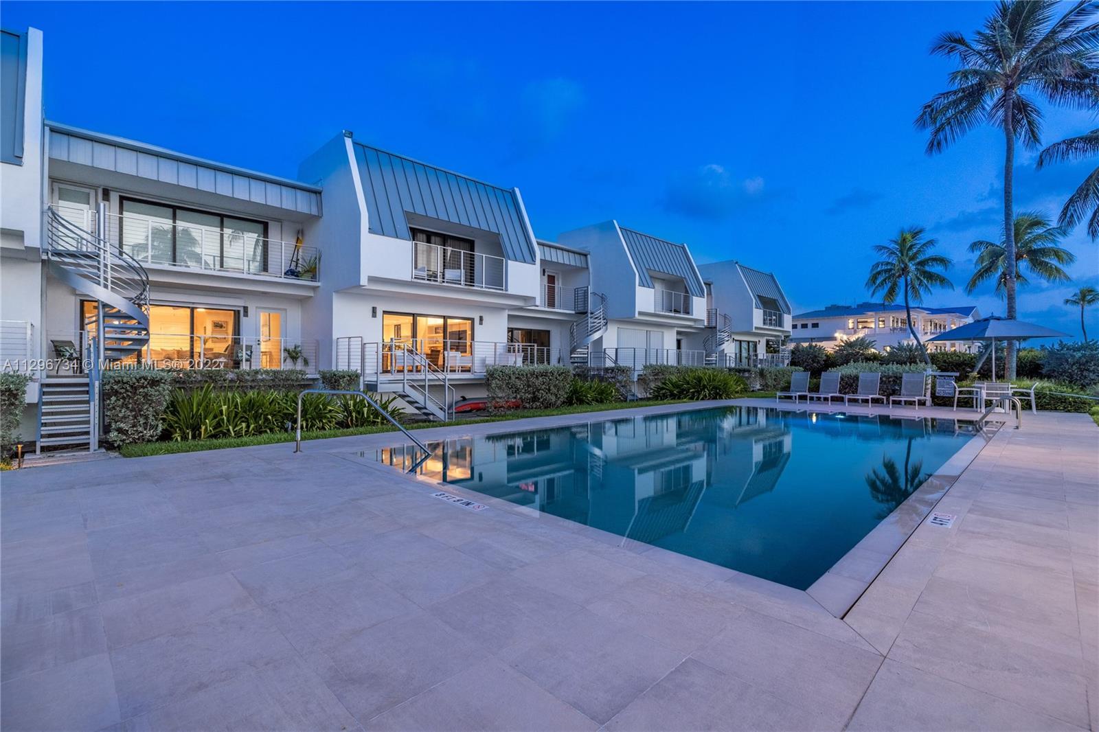 166 Harbor Drive, Unit 1A Key Biscayne, FL 33149 - Photo 17 of 86 a view of swimming pool with outdoor seating and a yard