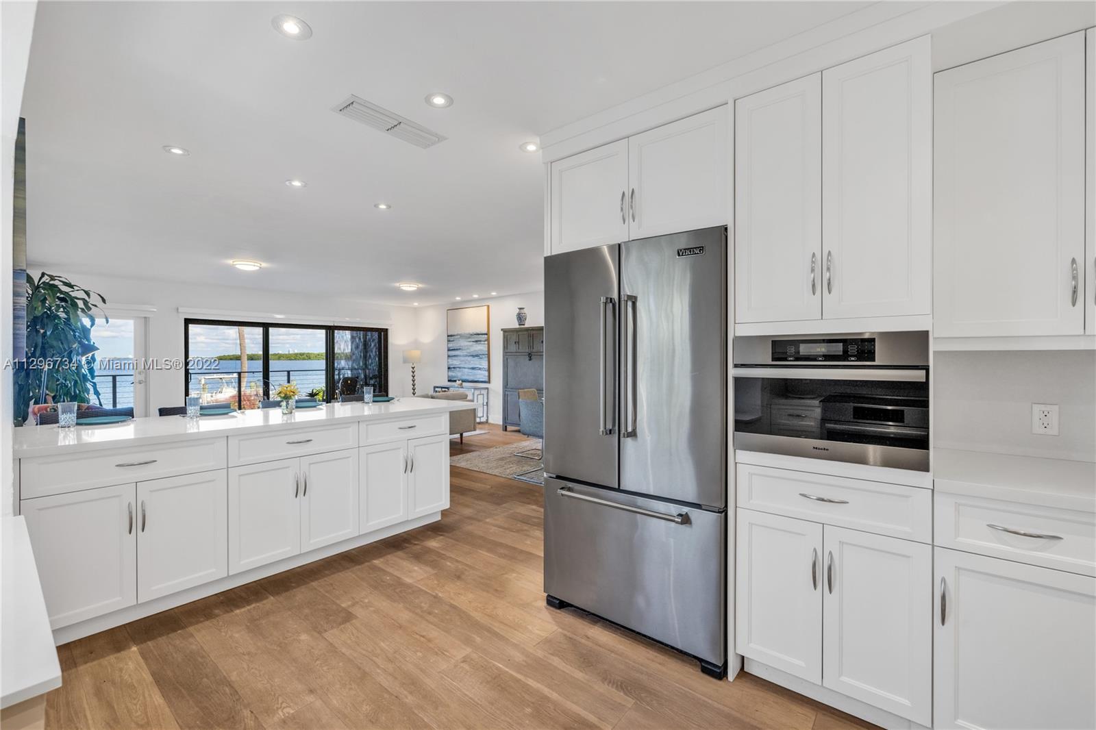 166 Harbor Drive, Unit 1A Key Biscayne, FL 33149 - Photo 19 of 86 a kitchen with stainless steel appliances a refrigerator sink and cabinets