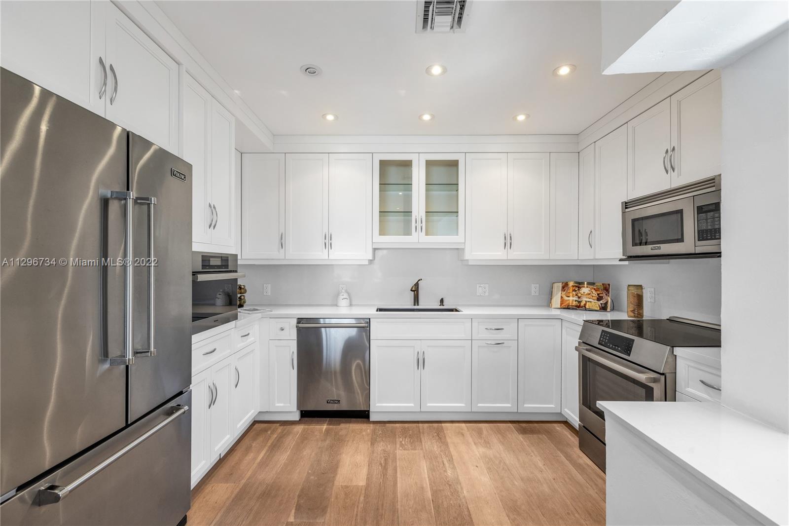 166 Harbor Drive, Unit 1A Key Biscayne, FL 33149 - Photo 21 of 86 a kitchen with stainless steel appliances a refrigerator sink and microwave