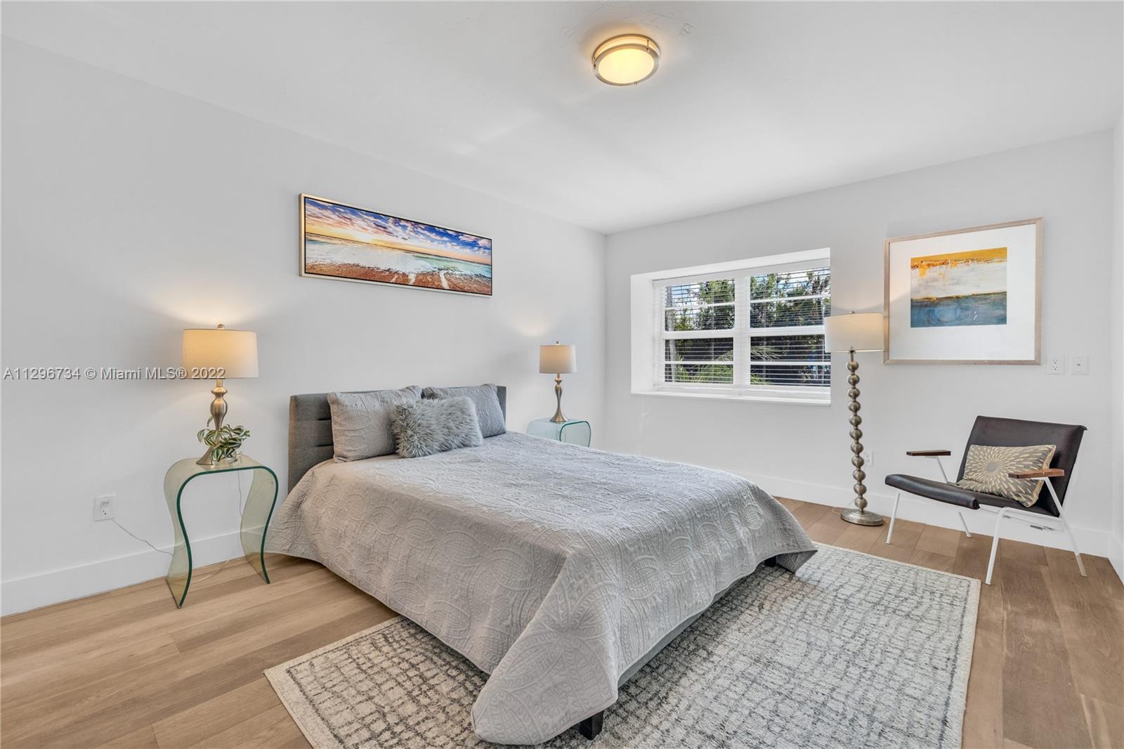 166 Harbor Drive, Unit 1A Key Biscayne, FL 33149 - Photo 28 of 86 a bedroom with bed and window