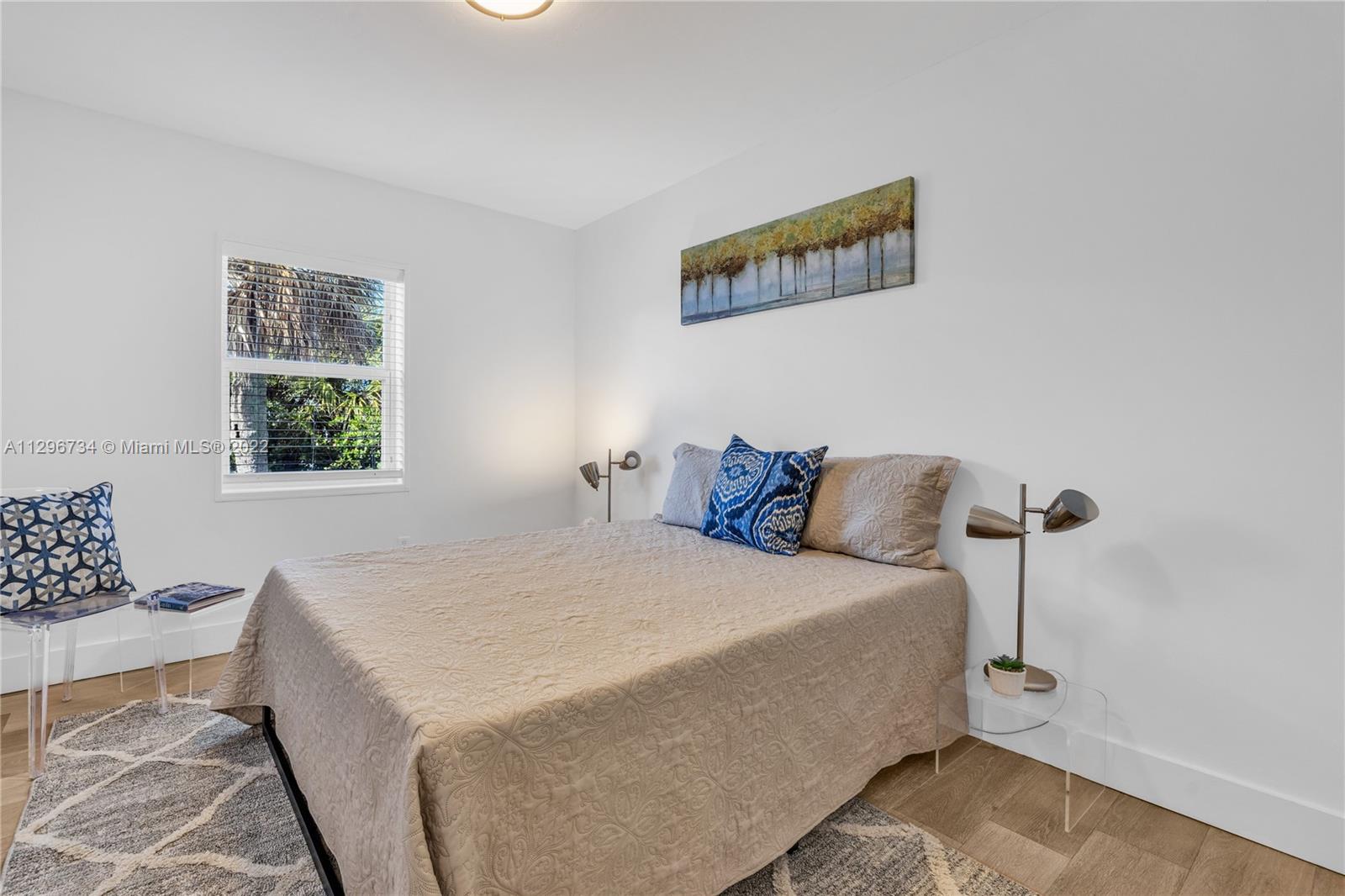 166 Harbor Drive, Unit 1A Key Biscayne, FL 33149 - Photo 30 of 86 a bedroom with a bed and a window