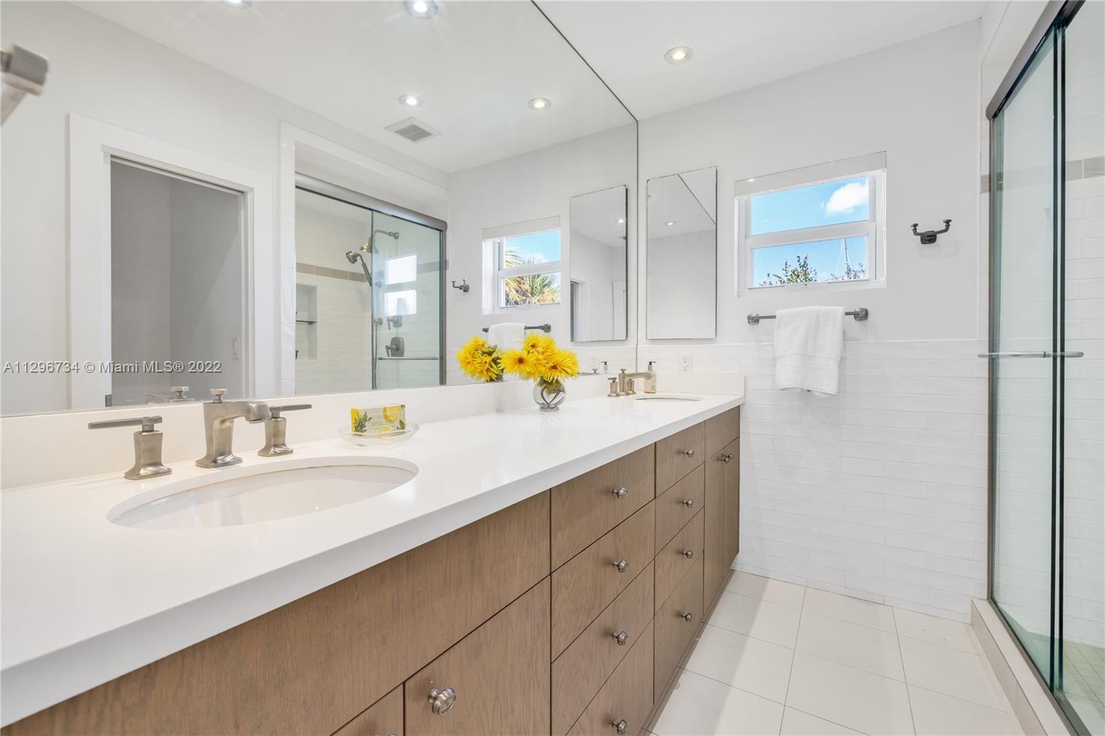 166 Harbor Drive, Unit 1A Key Biscayne, FL 33149 - Photo 31 of 86 a bathroom with a double vanity sink mirror and shower