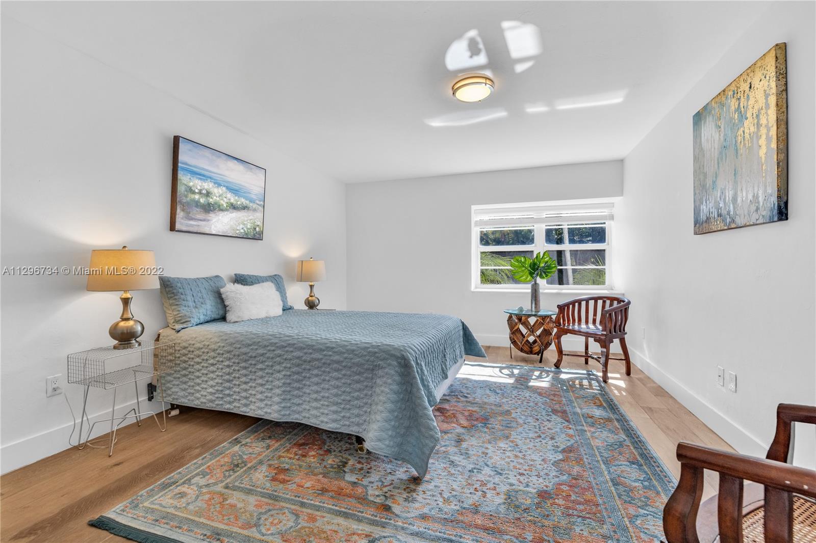 166 Harbor Drive, Unit 1A Key Biscayne, FL 33149 - Photo 34 of 86 a bedroom with a bed and a chandelier