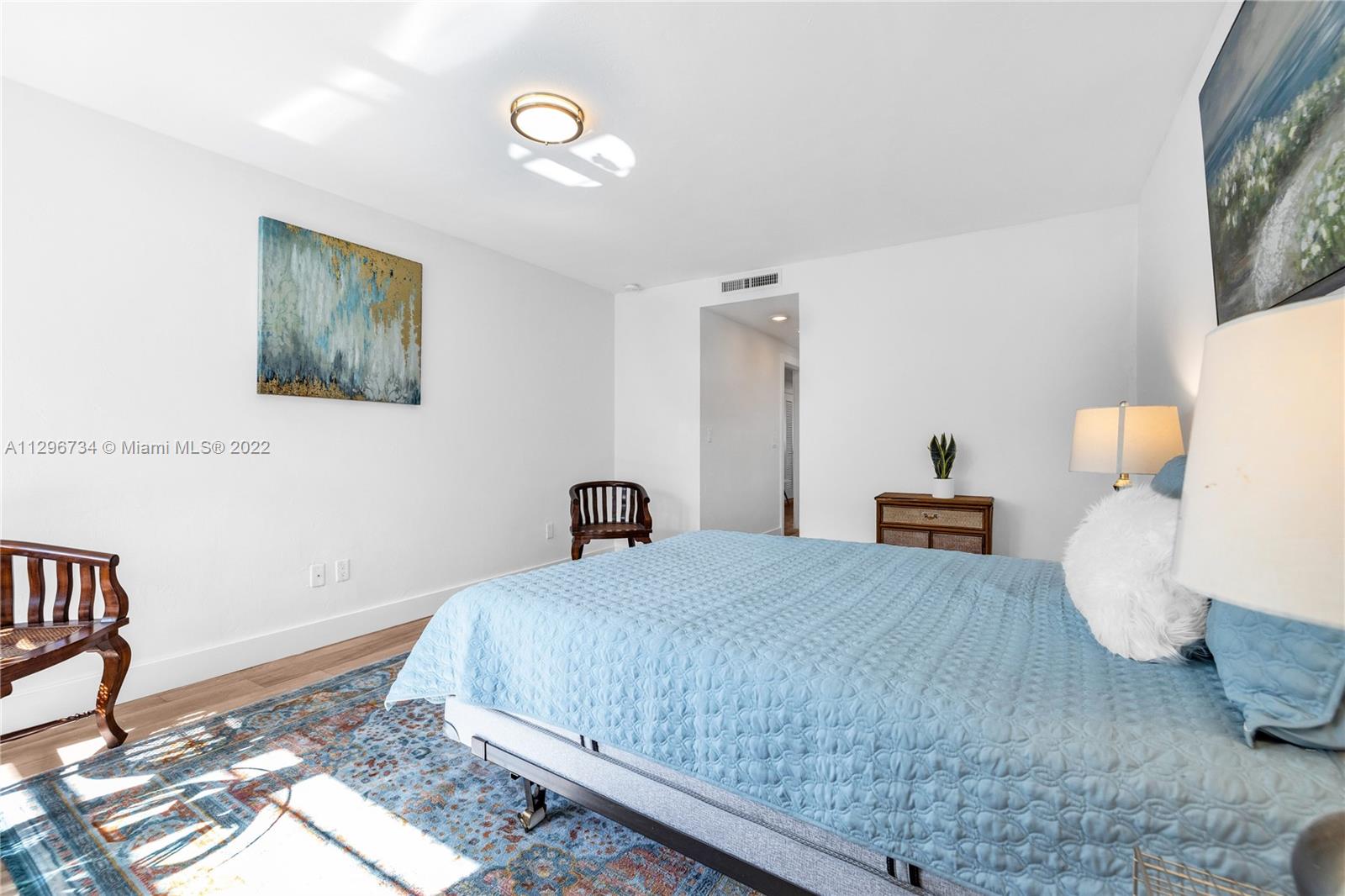 166 Harbor Drive, Unit 1A Key Biscayne, FL 33149 - Photo 35 of 86 a bedroom with a bed and wooden floor