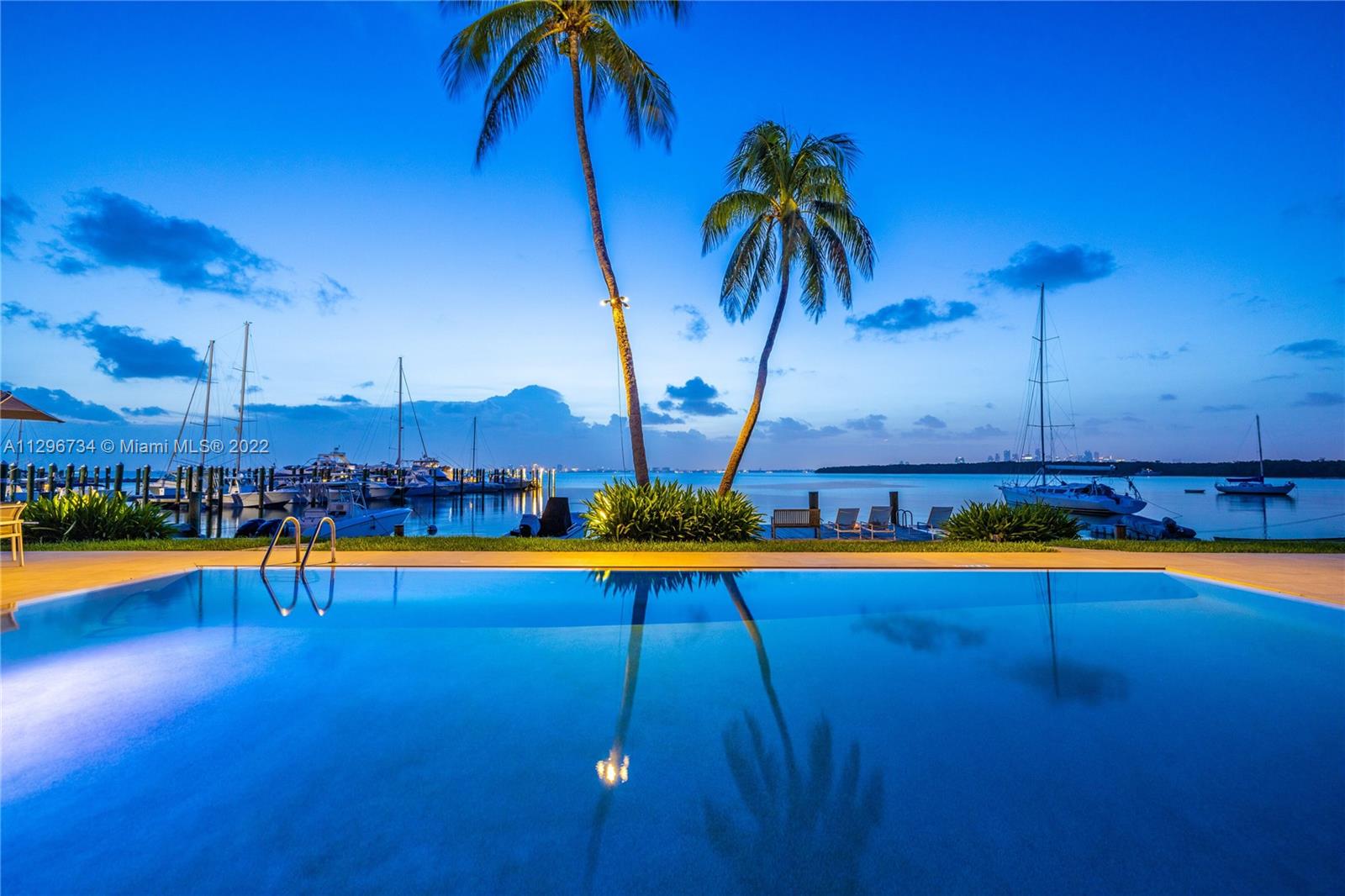 166 Harbor Drive, Unit 1A Key Biscayne, FL 33149 - Photo 45 of 86 a view of a swimming pool with lounge chair