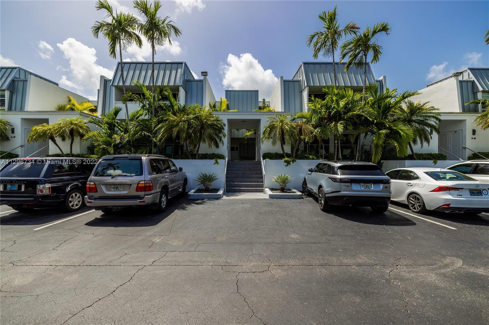 166 Harbor Drive, Unit 1A Key Biscayne, FL 33149 - Photo 48 of 86 a view of a car parked in front of a house