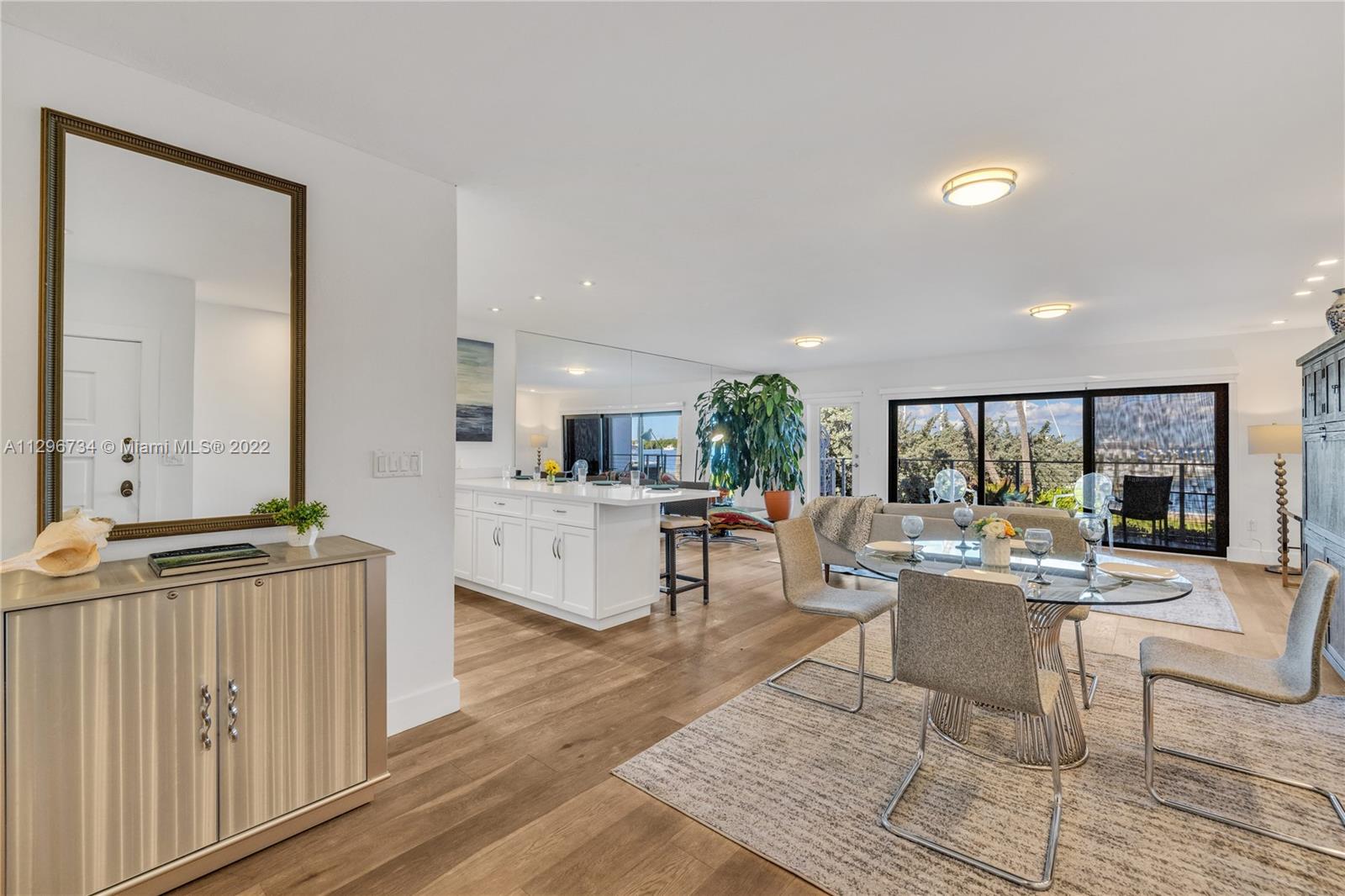 166 Harbor Drive, Unit 1A Key Biscayne, FL 33149 - Photo 6 of 86 a living room with furniture a large window and wooden floor